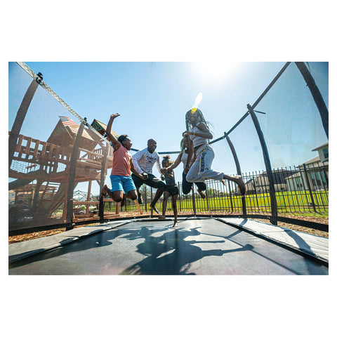 Avyna Pro-Line MAX 12 ft × 18 ft rectangle in-ground trampoline lifestyle view with safety enclosure