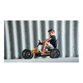 Child riding a BERG Buddy B-Orange pedal kart