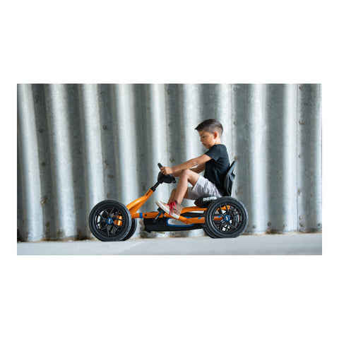 Child riding a BERG Buddy B-Orange pedal kart