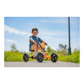 Child riding a BERG Buzzy Orange pedal kart