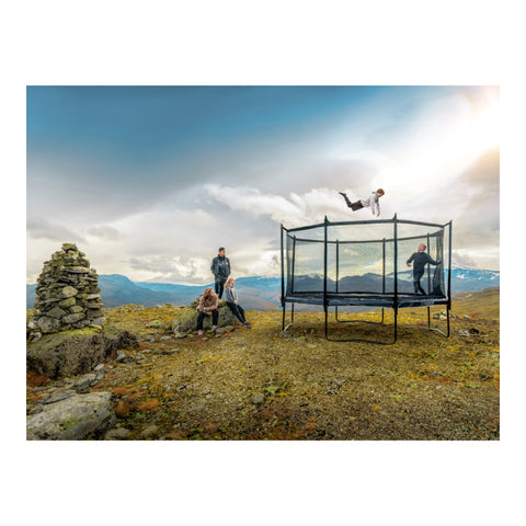 North Legend 16 × 11 ft oval trampoline in a rocky landscape